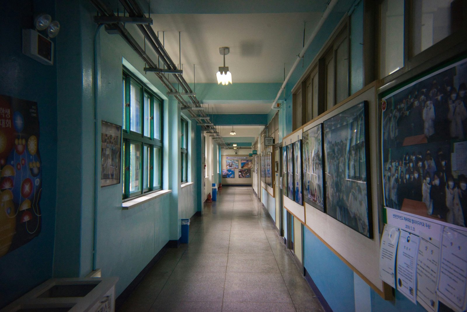 A school corridor lined with noticeboards